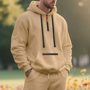 Detail of khaki men's fleece hoodie with half-zip, orange puller and kangaroo pocket