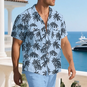 Detail of light blue Hawaiian shirt featuring palm tree prints and dual chest pockets