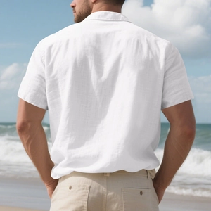 Close-up of breathable white linen shirt fabric and lapel collar in a beach setting