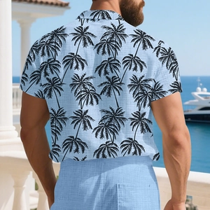 Rear view of a light blue short-sleeved men's Hawaiian shirt with black palm leaf prints