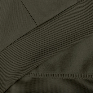 Close-up of olive green hoodie with ribbed hem and soft fleece lining texture