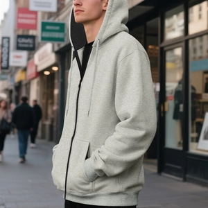 Detail of light grey zip-up hoodie featuring adjustable drawstrings and spacious pockets