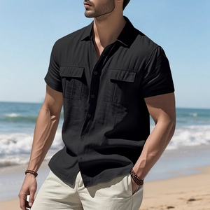 Detail of men's black linen short sleeve shirt with double pockets in casual coastal style