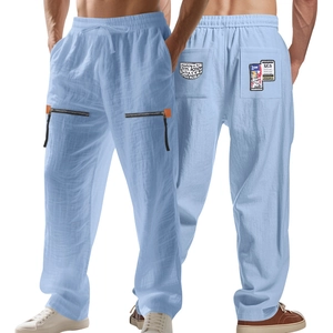 Detail view of men's linen pants showing drawstring waist and zipper pockets