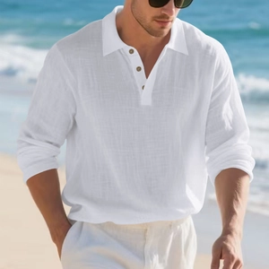 Detail of white linen polo shirt featuring a textured collar and wooden buttons outdoors