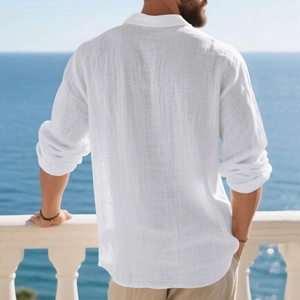 Detail of white linen long sleeve polo shirt showing breathable textured fabric on sea balcony