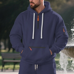 Detail of navy blue fleece hoodie featuring orange zipper accents and white drawstrings