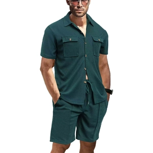 Detailed macro view of dark green waffle fabric texture on men's casual shorts and shirt