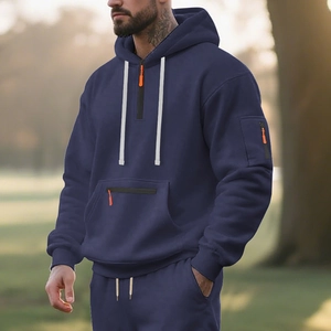 Detail of navy blue fleece hoodie with vibrant orange zipper and sleeve pocket