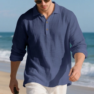 Detail of navy linen polo shirt featuring three wood texture buttons and a natural lapel collar