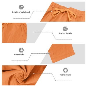 Detail view of orange linen pants showing elastic drawstring waist and fabric texture