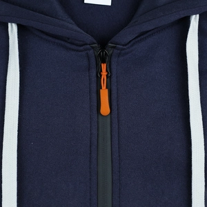 Detailed close-up of navy hoodie neckline featuring orange zipper pull and white drawstrings