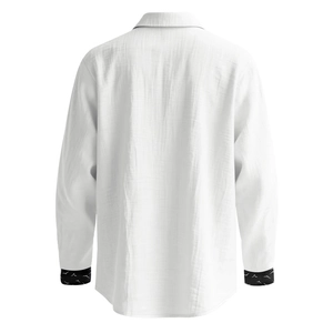 Detail of white linen blend shirt featuring a unique bird print pattern on the cuffs