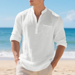 Detail of white linen shirt showing chest pocket, mandarin collar, and textured fabric