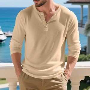 Détail du t-shirt Henley en maille côtelée beige avec boutons dans un cadre côtier