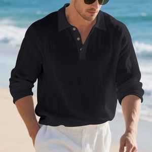 Detailed view of linen texture and button neckline on black men's long sleeve polo shirt