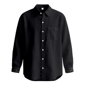 Detail of black linen shirt showing white bird print on pocket and collar with size L label