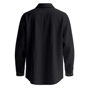 Rear view of black linen shirt showing textured fabric and white bird print on the cuffs