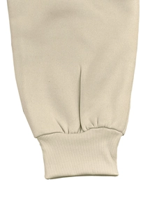 Detailed close-up of cream ribbed cuffs on a fleece hoodie or sweatpants set