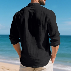 Rear view of man in black linen Henley shirt on beach showing casual fit and breathable fabric