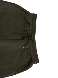 Detail view of elastic waistband and drawstring on olive green fleece sweatpants