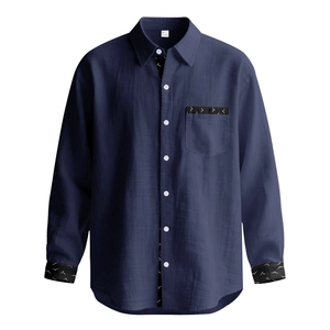 Detail showing deep blue linen texture and white bird print on shirt pocket and cuffs