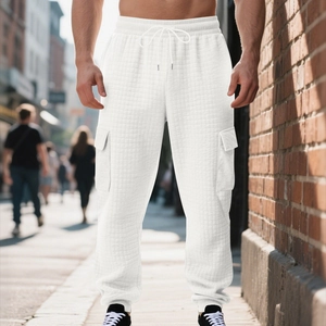 Detail of white waffle texture joggers featuring cargo pockets and drawstring waist