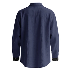 Detail of navy linen shirt sleeve showing textured fabric and bird print on the inner cuff