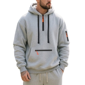 Men's grey fleece half-zip hoodie and drawstring joggers set with orange zipper accents