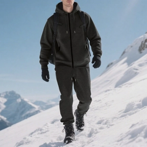 Men's winter fleece tracksuit set with hoodie and joggers worn in snowy outdoor terrain