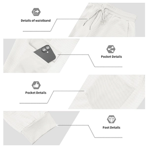 Detail view of white waffle knit joggers featuring elastic drawstring waist and ribbed cuffs