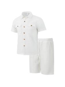 Detail of white waffle knit shirt with lapel collar, chest pockets and shell buttons