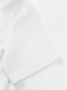 Detailed close-up showing white waffle weave fabric texture and quality stitching