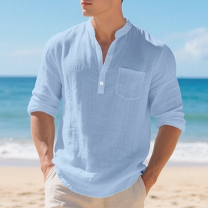 Detail of light blue linen shirt featuring a mandarin collar and textured cotton fabric