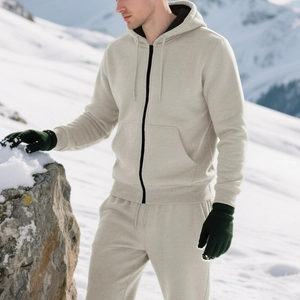Detailed texture of beige fleece tracksuit with zipper hood and drawstring jogger pants