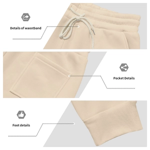 Detail view of elastic waistband with drawstring and ribbed cuffs on beige jogger pants