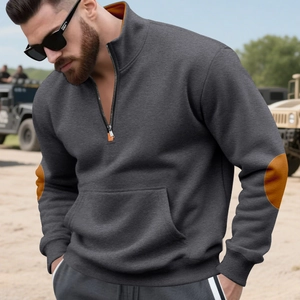 Detail van grijze sweatshirt met halve rits, oranje kraagvoering en elleboogstukken