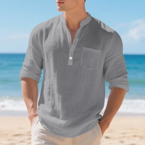 Detail of grey linen Henley shirt with standing collar and chest pocket on beach