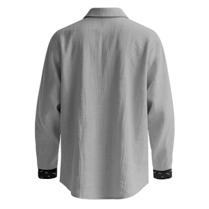 Detail view of the back of a men's grey linen shirt with textured fabric and sleeve accents