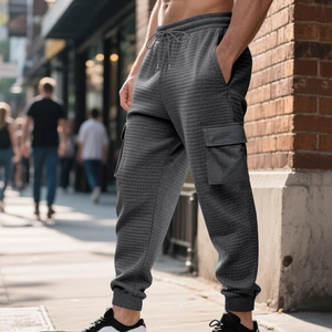 Macro shot of dark grey waffle texture fabric on men cargo jogger pants with side pocket