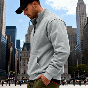 Detail view of men's quarter-zip light grey fleece sweatshirt with ribbed cuffs and pocket