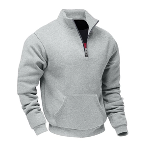 Close-up of light gray half-zip sweatshirt featuring ribbed cuffs and large kangaroo pocket