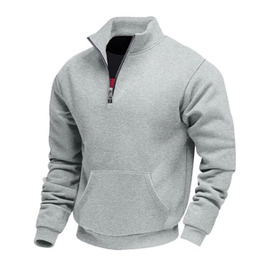 Detail of light gray half-zip sweatshirt featuring a stand collar and kangaroo pocket