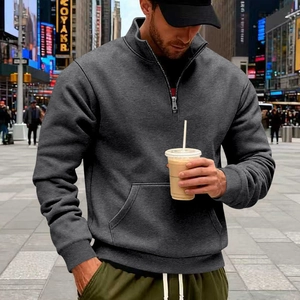 Street style view of men's grey half-zip sweatshirt with stand collar and front pocket