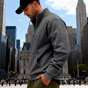 Detail of dark gray men's half-zip sweatshirt with stand collar and knit texture
