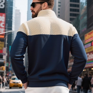 Dettaglio felpa da uomo blu navy con spalle trapuntate a rombi beige e collo alto