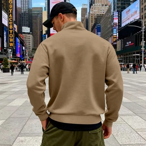 Rear view of khaki half-zip sweatshirt for men in a high-quality urban street setting