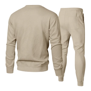 Macro shot of 3D geometric twill texture on beige men's knitted sweatshirt and jogger set