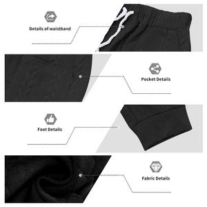 Detailoverzicht van zwarte getextureerde joggers met trekkoord en elastiek