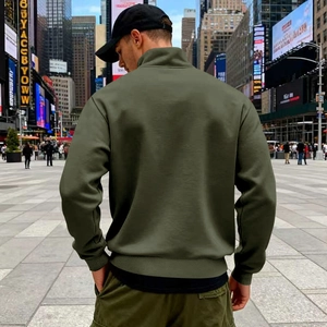 Rear view of an army green quarter-zip sweatshirt featuring ribbed cuffs and hem